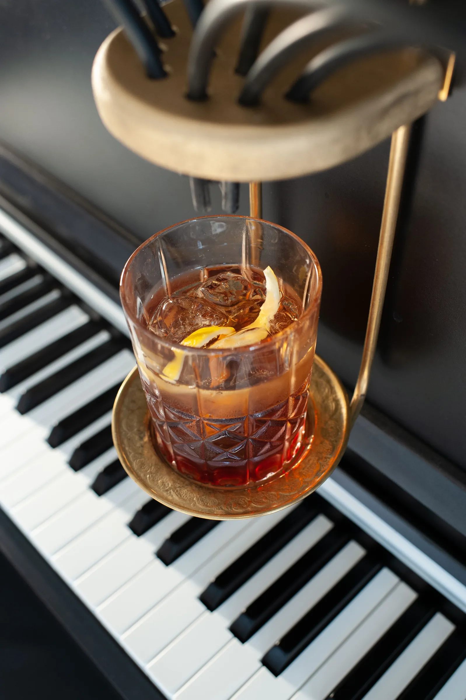Cocktail servi dans un verre en cristal, posé au-dessus du clavier du Pianocktail